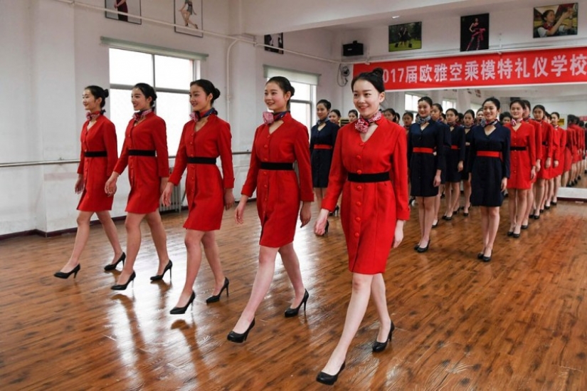 Chinese flight attendants are taught to smile, walk, stand and sit Chinese flight attendants are taught to smile, walk, stand and sit