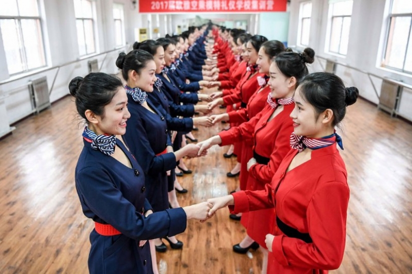 Chinese flight attendants are taught to smile, walk, stand and sit Chinese flight attendants are taught to smile, walk, stand and sit