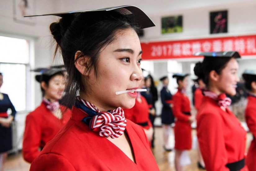 Chinese flight attendants are taught to smile, walk, stand and sit Chinese flight attendants are taught to smile, walk, stand and sit