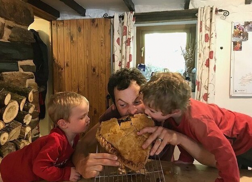 Happy father in honor of the birth of his son baked a cake the size of a child