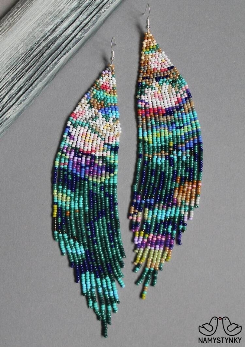A talented Ukrainian woman makes beaded earrings based on the plots of famous paintings