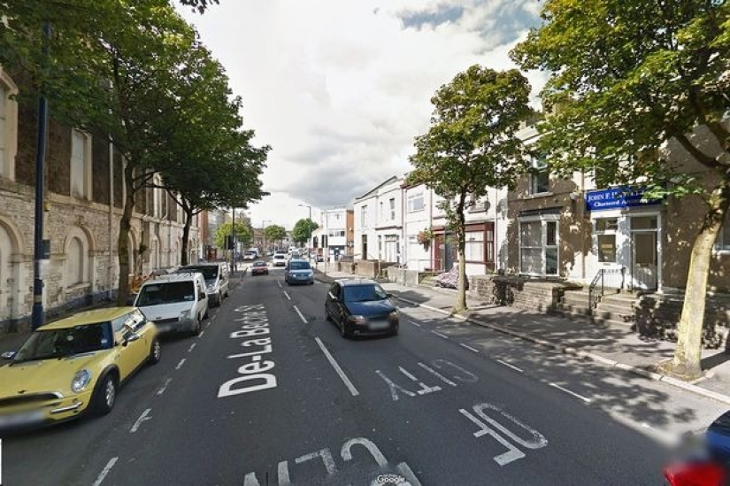 Silent protest: A British man has been standing in the middle of the road in the same place for seven years, creating traffic jams