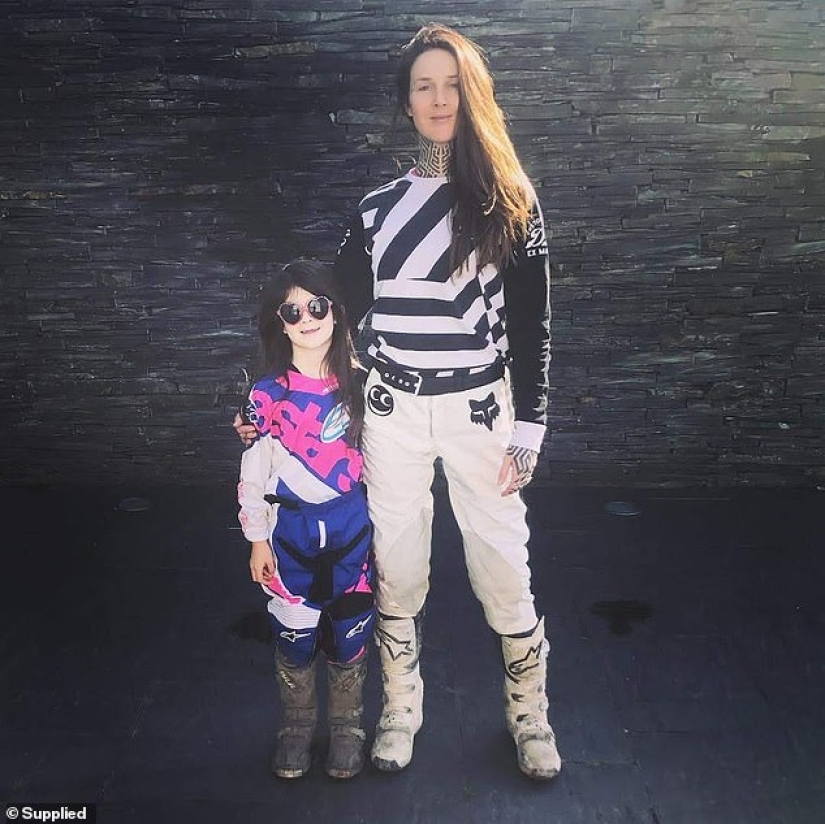 The cool kid: a seven-year-old biker rides a motorcycle with her mother, who loves extreme sports