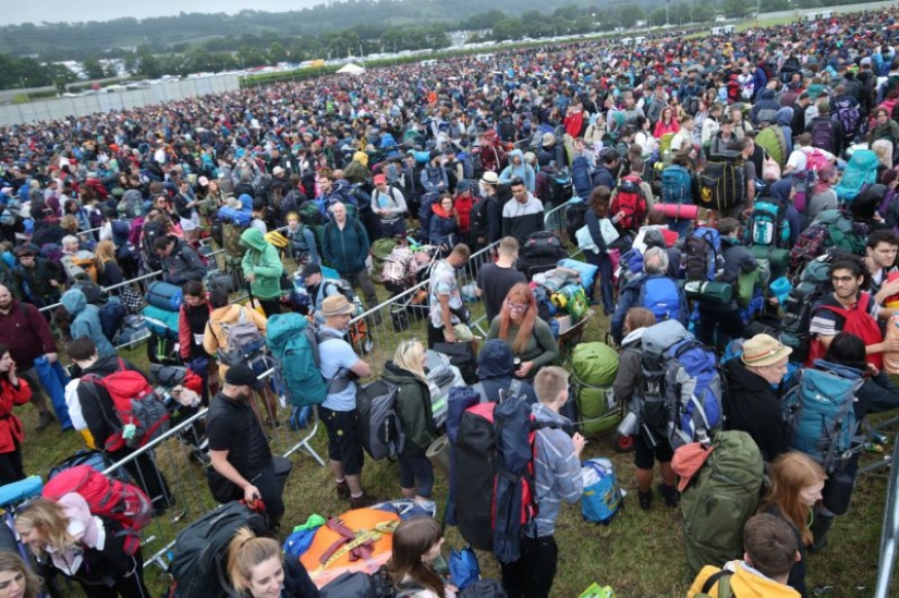 Rubber mood: Glastonbury greets participants in raincoats and with a killer dose of alcohol