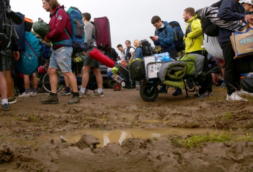 Rubber mood: Glastonbury greets participants in raincoats and with a killer dose of alcohol