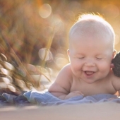 The baby and the puppy were born on the same day and now they think they are brothers