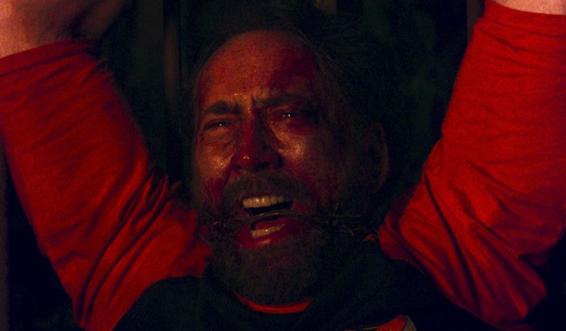 Why is a bloody Nicolas Cage running through the woods with a chainsaw