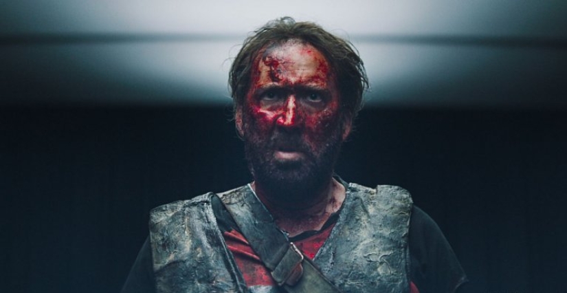 Why is a bloody Nicolas Cage running through the woods with a chainsaw