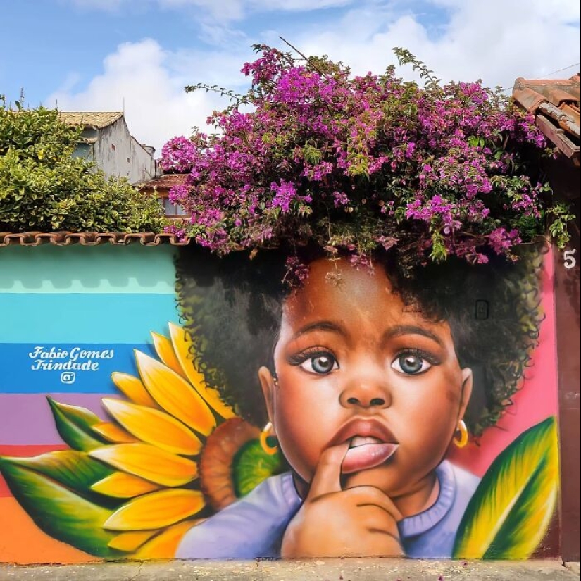 Artista callejero continúa pintando retratos en paredes junto a árboles que también sirven como cabello Artista callejero continúa pintando retratos en paredes junto a árboles que también sirven como cabello