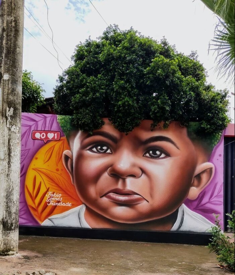 Artista callejero continúa pintando retratos en paredes junto a árboles que también sirven como cabello Artista callejero continúa pintando retratos en paredes junto a árboles que también sirven como cabello