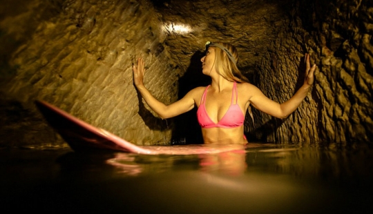 Indiana Jane: An American woman on a surfboard explores the skeletal catacombs of Paris