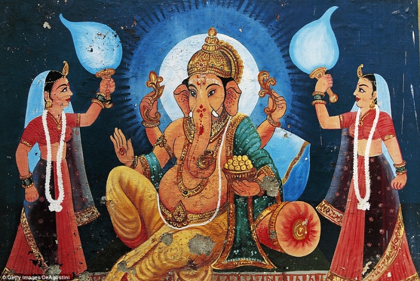 Residents of an Indian village worship a boy with a deformed head as the god Ganesha