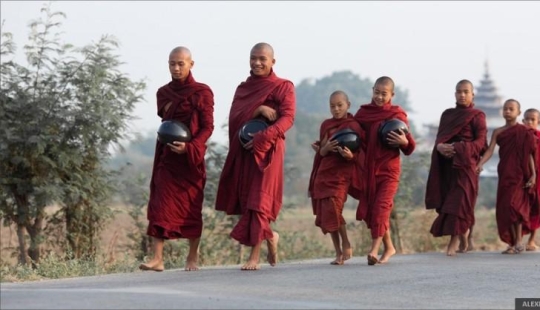 Sunrise over rice fields and monks feeding