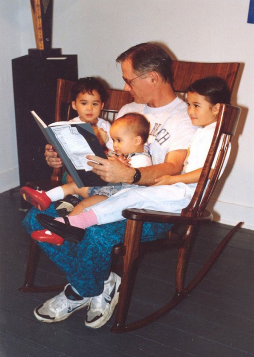 The father created a triple rocking chair to read fairy tales to his children The father created a triple rocking chair to read fairy tales to his children