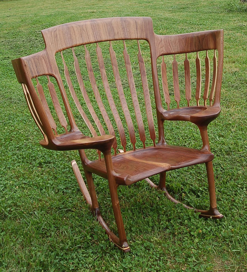 The father created a triple rocking chair to read fairy tales to his children The father created a triple rocking chair to read fairy tales to his children