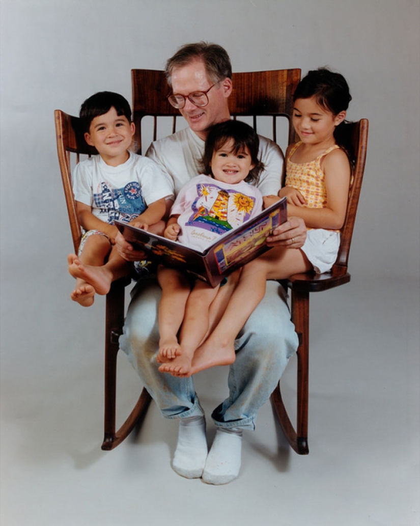 The father created a triple rocking chair to read fairy tales to his children The father created a triple rocking chair to read fairy tales to his children