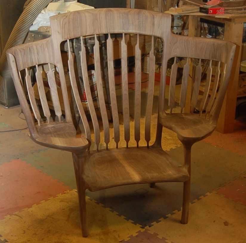 The father created a triple rocking chair to read fairy tales to his children The father created a triple rocking chair to read fairy tales to his children