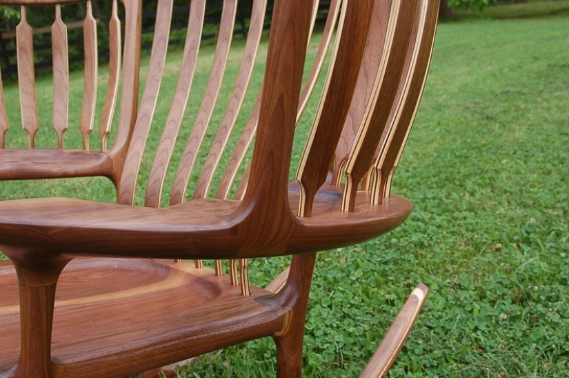 The father created a triple rocking chair to read fairy tales to his children The father created a triple rocking chair to read fairy tales to his children