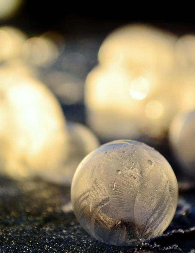 Crystal balls — a girl photographs soap bubbles in the cold Crystal balls — a girl photographs soap bubbles in the cold
