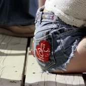 Blue denim shorts are a favorite trend of American girls of the 70s Blue denim shorts are a favorite trend of American girls of the 70s