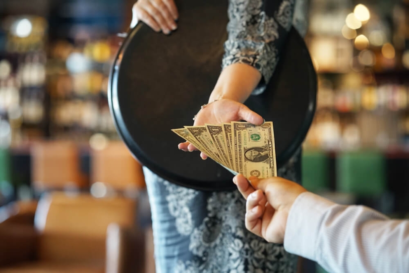 Where did the tradition of leaving tips come from and why do we misunderstand it