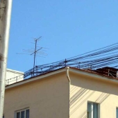 Who and why stretches wires between houses Who and why stretches wires between houses