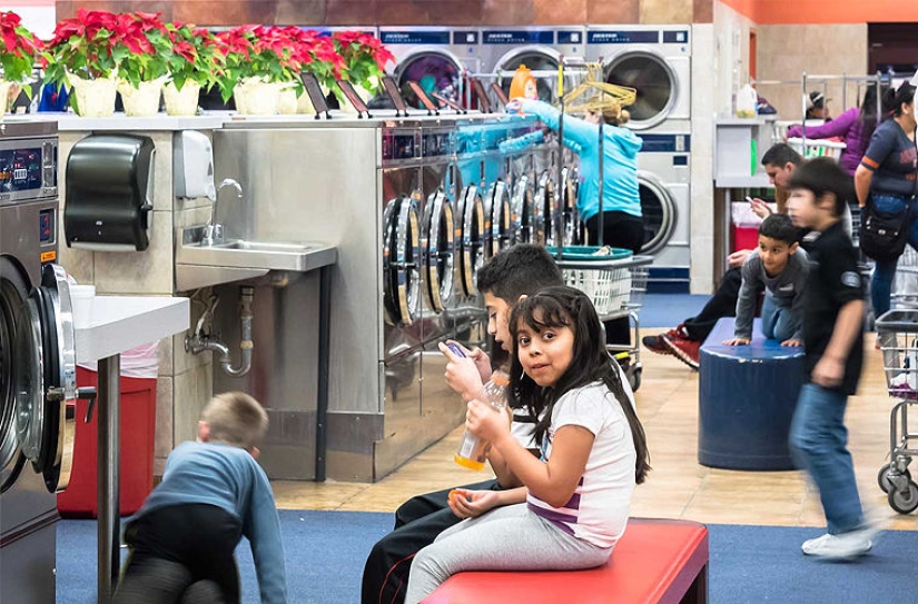 Why do Americans do laundry in laundries and not at home?