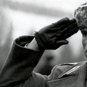 Why do the military salute by putting their hand to their head